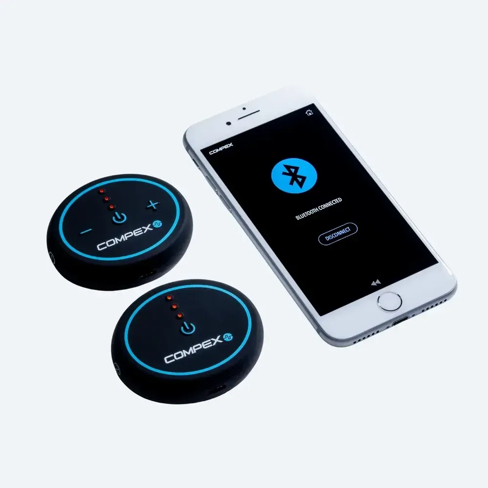 Two pods beside a phone showing the Compex app connecting over Bluetooth