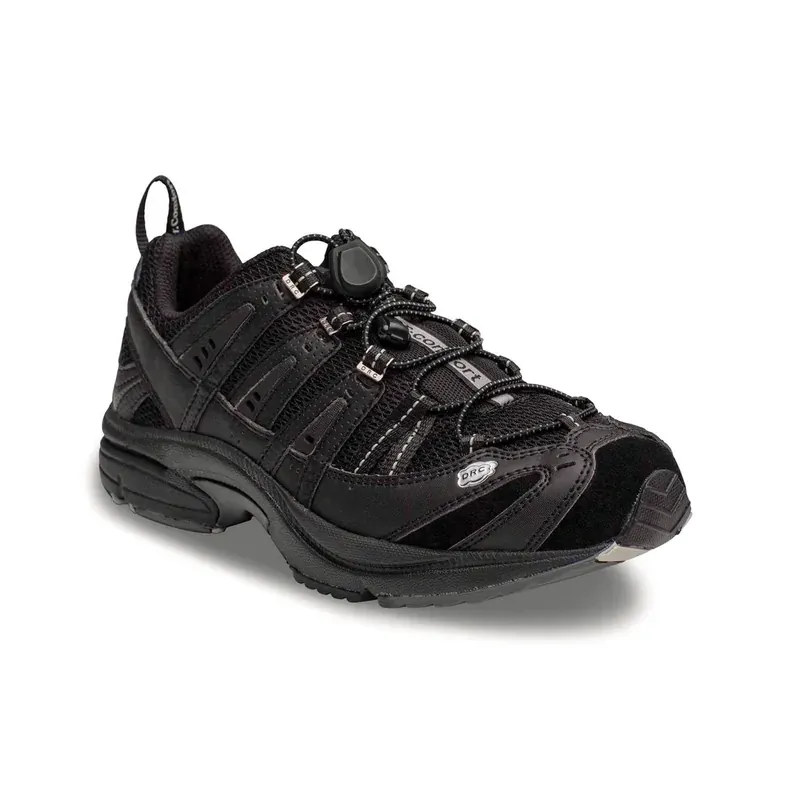 The Dr. Comfort Performance men's cross-trainer in black, outside profile showing the toggle lace and the mesh panels