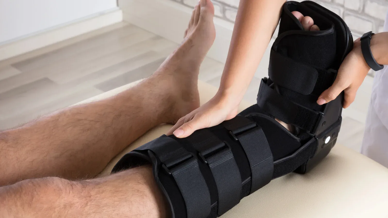 A CAM moon boot walker being fitted to a patient's lower leg