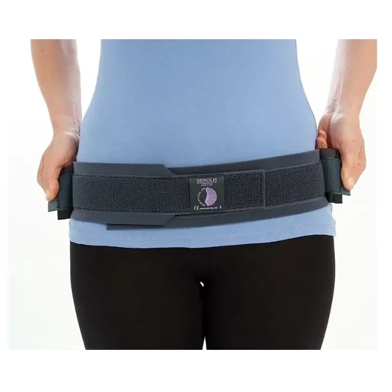 The belt worn low on the hips over a T-shirt, with both side straps pulled forward to tension it
